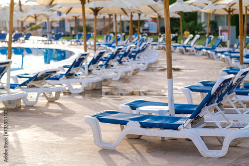 Sunbeds near swimming pool at luxury resort © laowaika