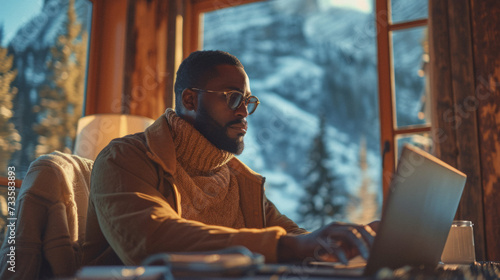 African American entrepreneur working remotely from a breathtaking mountain view, proving that work can happen from anywhere.