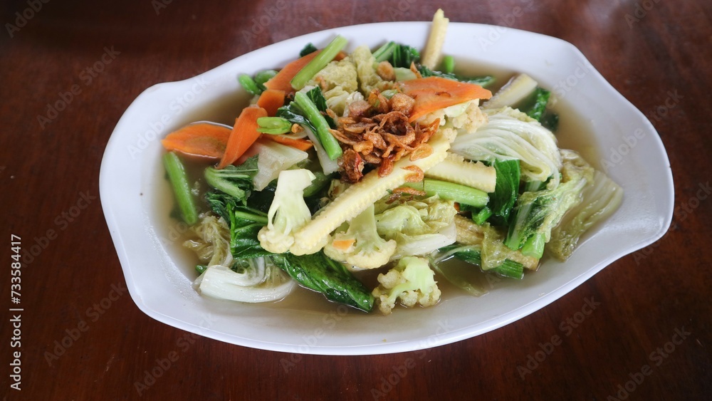 Cap cay or cap cai is a popular stir fried dish that originates from Chinese cuisine. this dish contains many vitamins and minerals as it is made mainly of vegetables. served on bowl. selected focus Cap cay or cap cai is a popular stir fried dish that originates from Chinese cuisine. this dish contains many vitamins and minerals as it is made mainly of vegetables. served on bowl. selected focus