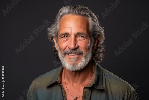 Portrait of a happy senior man with grey hair and beard. © Iigo