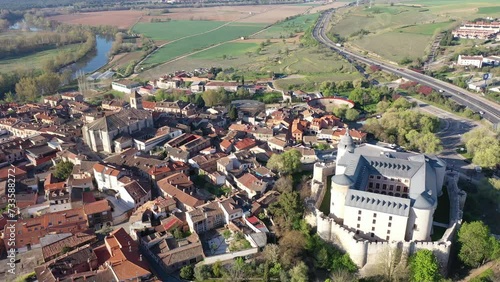 Aerial view of Spanish township of Simancas in province of Valladolid with Romanesque medieval church of El Salvador and walled fortified castle surrounded by residential buildings on sunny spring day photo