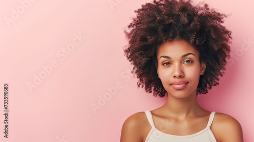 Happy Afro-American woman with curly hair smiling in a close-up portrait