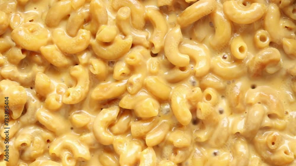 Boiled Macaroni and Cheese Sauce Cooking in a Pan. Top view Boiled Macaroni and Cheese Sauce Cooking in a Pan. Top view