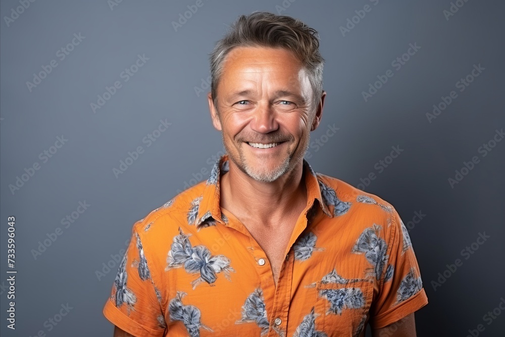 Handsome middle aged man in a summer shirt smiling at the camera. Handsome middle aged man in a summer shirt smiling at the camera.