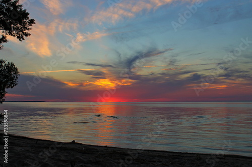Colorful sunset on the shore of Lake Chudskogo. Pskov region, Russia.