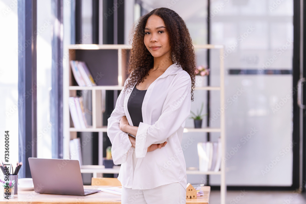 A young woman cheerful standing In the office room. A young woman cheerful standing In the office room.