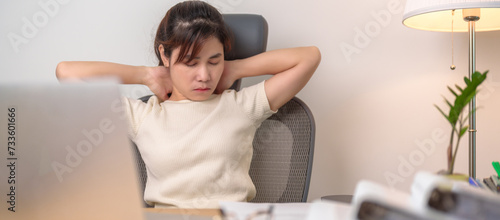 Woman having Neck and Shoulder pain during work long time on workplace. due to fibromyalgia, rheumatism, Scapular pain, office syndrome, stretching and ergonomic concept