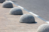 Concrete balls as limiters for parking cars on the road