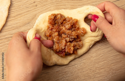 Woman preparing buns with jam from doug photo