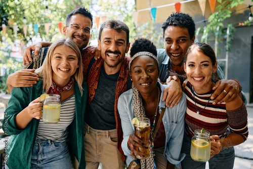 Sticker Multiracial group of happy friends having drink and looking at camera