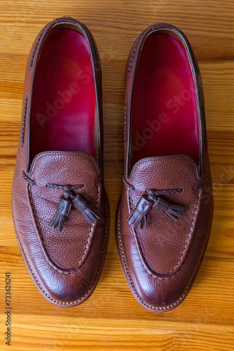 Closeup Upper View of Two Pair of Traditional Formal Stylish Brown Pebble Grain Tassel Loafer Shoes