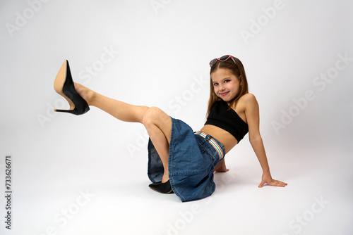 Portrait of a cute girl wearing high heels shoes photo