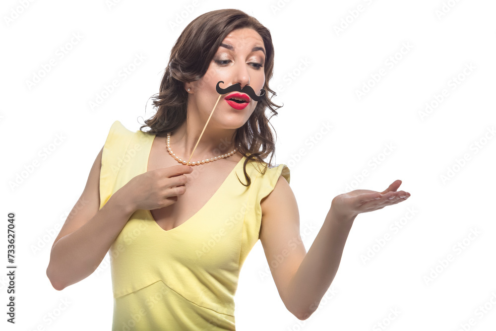 Funny Playful Portrait of Smiling Happy Laughing Caucasian Brunette Girl in Posing with Artificial Moustache in Yellow Dress With Hand Lifted Funny Playful Portrait of Smiling Happy Laughing Caucasian Brunette Girl in Posing with Artificial Moustache in Yellow Dress With Hand Lifted