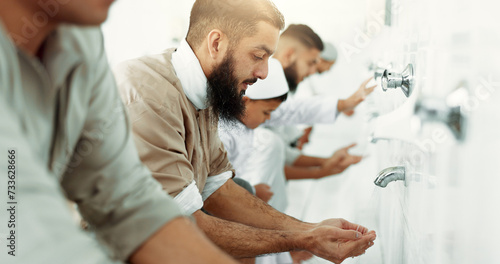 Muslim, religion ritual and men washing before prayer in bathroom for purity, and cleaning. Islamic, worship and faith of group of people with wudu together at a mosque or temple for holy practice photo