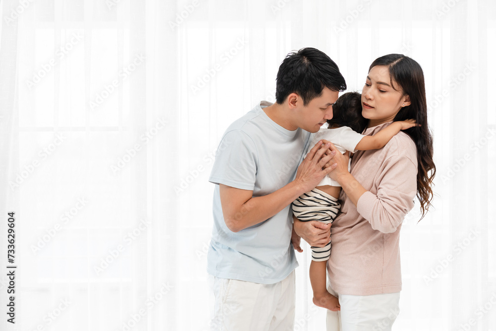 father and mother holding and hugging with toddler baby on white window background. happy family father and mother holding and hugging with toddler baby on white window background. happy family