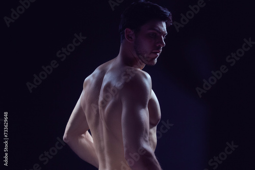 Closeup Image of Confident Thinking Caucasian Bodybuilder Athlete Man Posing With Naked Torso Against Dark © danmorgan12