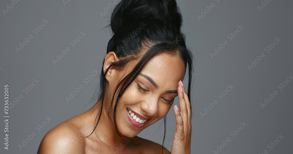 Fototapeta premium Face touch, skincare and smile of woman in studio isolated on gray background. Portrait, natural beauty and hand of model in spa facial treatment for aesthetic, glow and cosmetic wellness for health