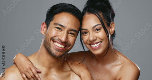 Couple, smile and care for skincare, love and portrait with moisturizer in studio by gray background. Happy people, dermatology and hug for cosmetics, hydration and creme or happy for skin treatment