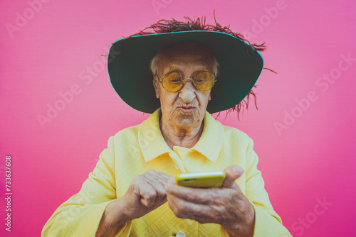 Funny grandmother portraits. Senior old woman, interacting with a smartphone. Concept about seniority