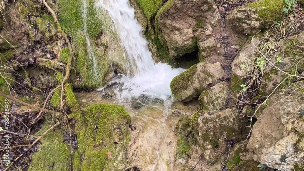 Powerful waterfall in the mountains, water falls among stones, moss and plants. Powerful waterfall in the mountains, water falls among stones, moss and plants.