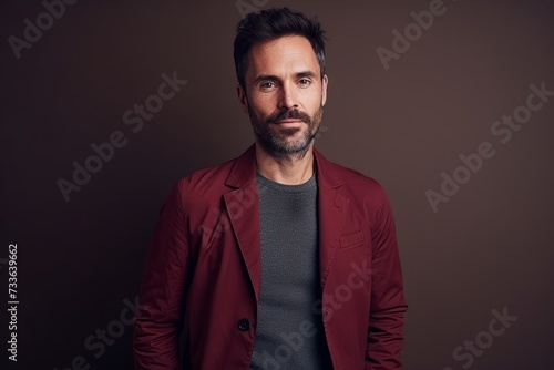 Portrait of a handsome man in a red jacket. Men's beauty, fashion.