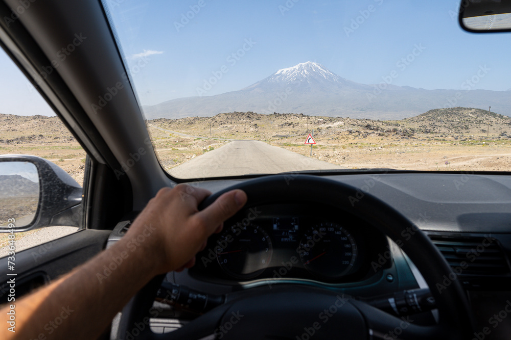 View of Ararat mountain though the car windscreen. Driver seat view over desert road in Southeast Anatolia region of Turkey