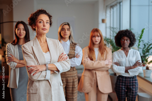 Serious businesswoman posing in front of her female colleagues