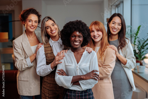 Team of diverse businesswomen posing together and laughing