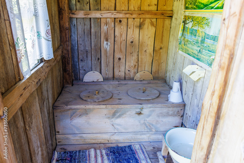 Fotografie Rustic old-fashioned outhouse for two