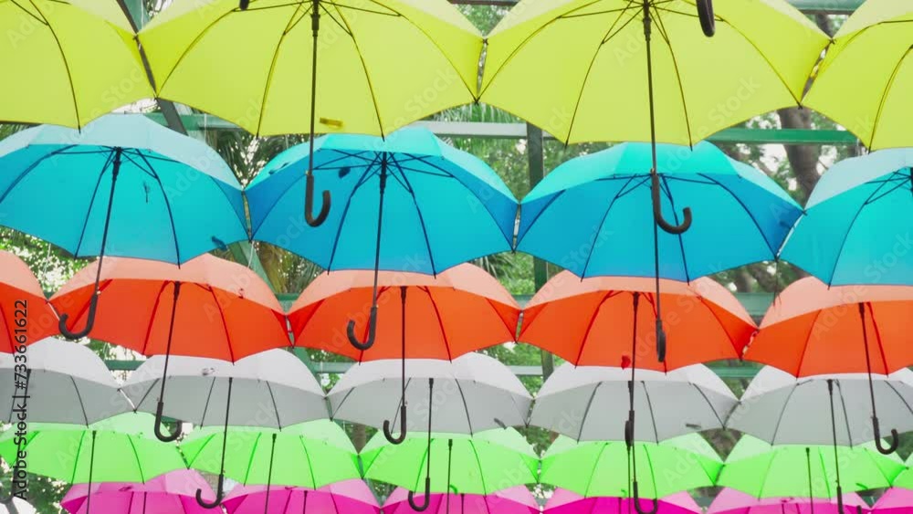 Walking under canopy of umbrellas in a park. Garden decor Walking under canopy of umbrellas in a park. Garden decor