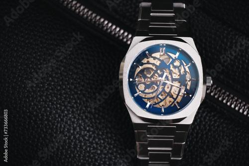 Metal mechanical wristwatch on a black background. Stock photo