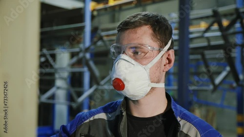 An engineer at the factory in the raspirator controls the machine