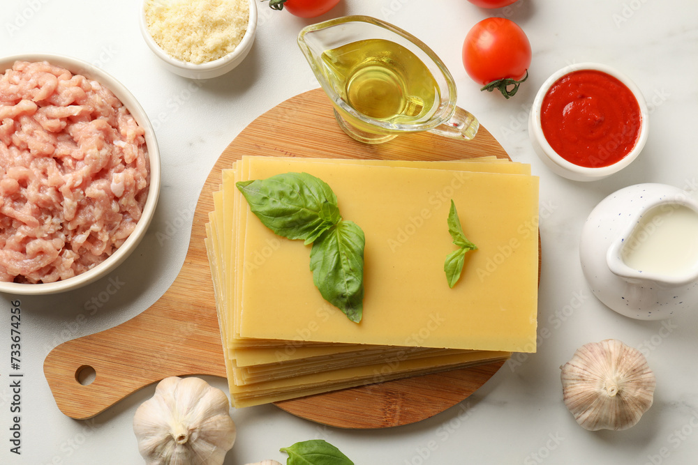 Ingredients for lasagna on white marble table, flat lay