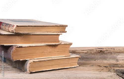 Old books on textured wooden surface isolated on white background
