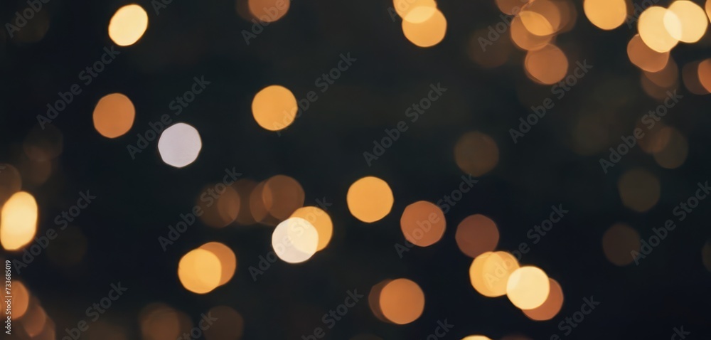 Fototapeta premium A scattering of golden bokeh highlights on a dark background