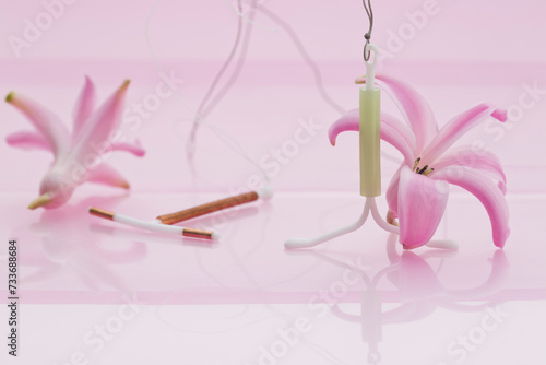 Valokuva Close-up of intrauterine device leaning on pink hyacinthus blossom and intrauter
