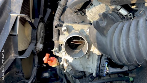 Checking and examining of a car Throttle Body for repairing and cleaning work.