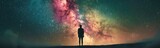 Starry sky with a person standing in front of a colorful galaxy. Banner