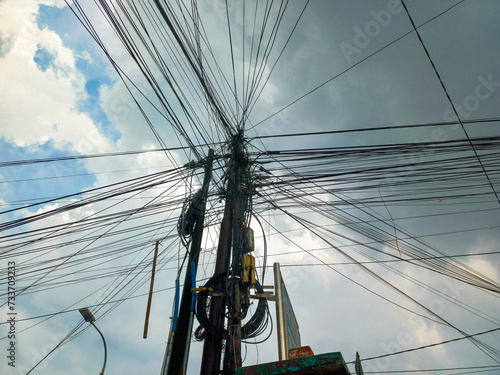 Messy power cables on poles in Indonesia