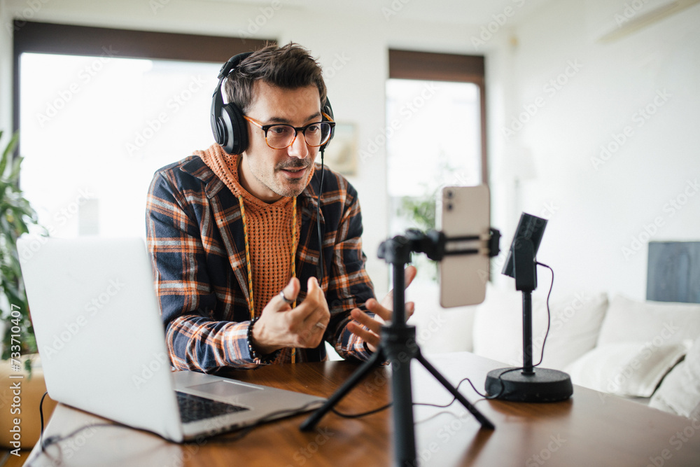 Man as mental health influencer making video for social media. Influencer, doing telepsychology, creating online content about mental health, well-being, teaching breath exercises.