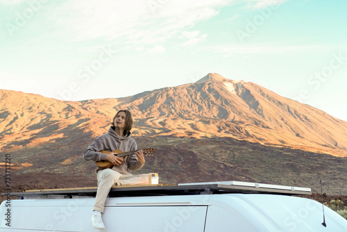Man Playing Guitar on Van Roof in Teide Mountain