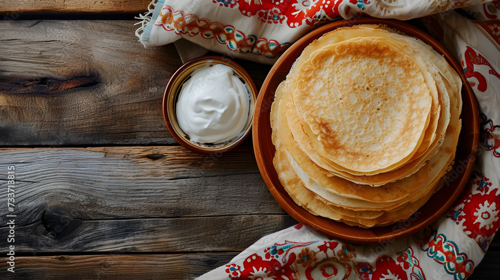 banner Shrovetide pancakes with sour cream closeup top view on wooden background with space for text banner Shrovetide pancakes with sour cream closeup top view on wooden background with space for text