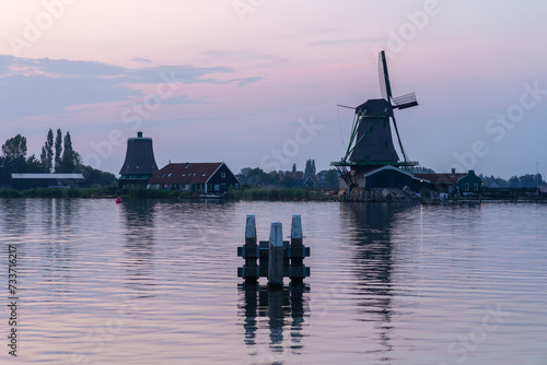 Windmills in the beautiful village of Zaanse Schans in Netherlands at sunset