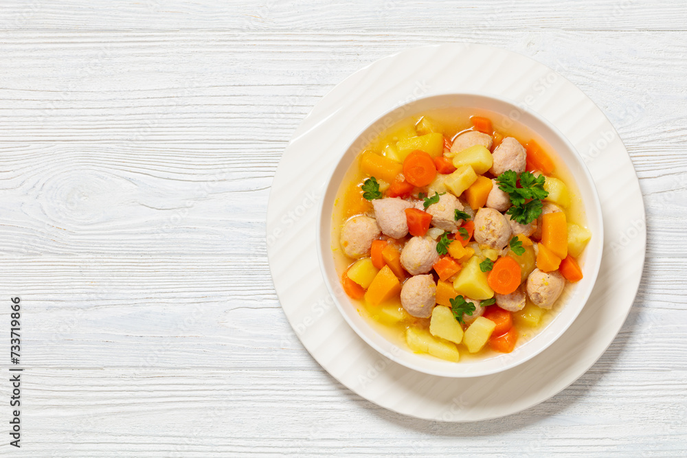 finnish sausage soup with vegetables in white bowl finnish sausage soup with vegetables in white bowl