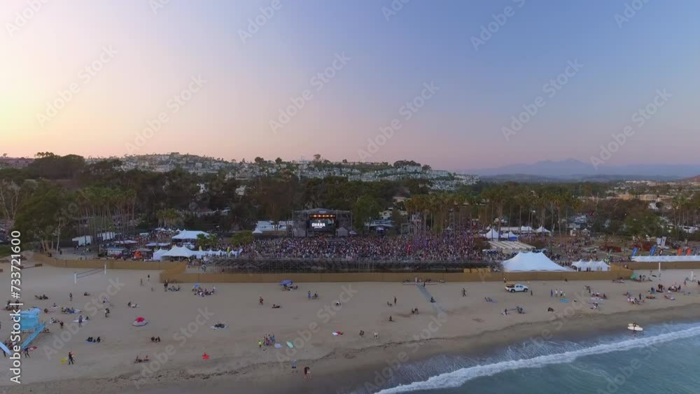 Aerial Shot Of People At Musical Concert Venue By Beach, Drone Flying Forward Over Wavy Sea During Sunset - Dana Point, California Aerial Shot Of People At Musical Concert Venue By Beach, Drone Flying Forward Over Wavy Sea During Sunset - Dana Point, California