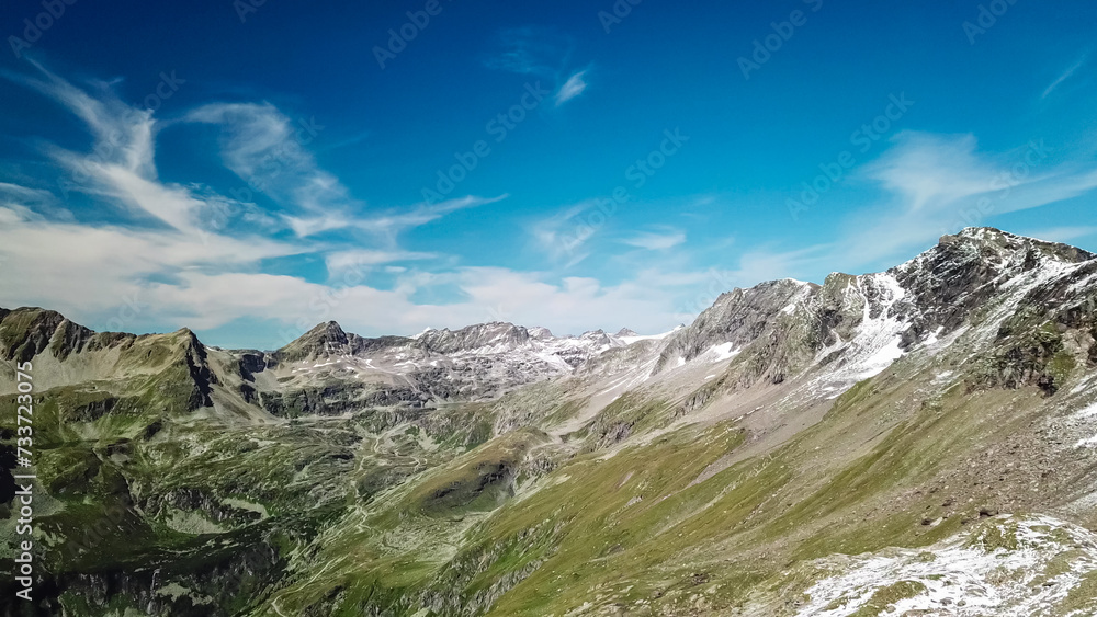 Panoramic view of majestic mountain peaks of High Tauern seen from Feldseekopf, Carinthia Salzburg, Austria. Idyllic hiking trail in Goldberg group in wilderness of Austrian Alps. Wanderlust. Tranquil