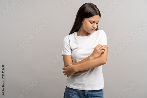Bild auf Leinwand Teen suffering from itching, scratching painful skin