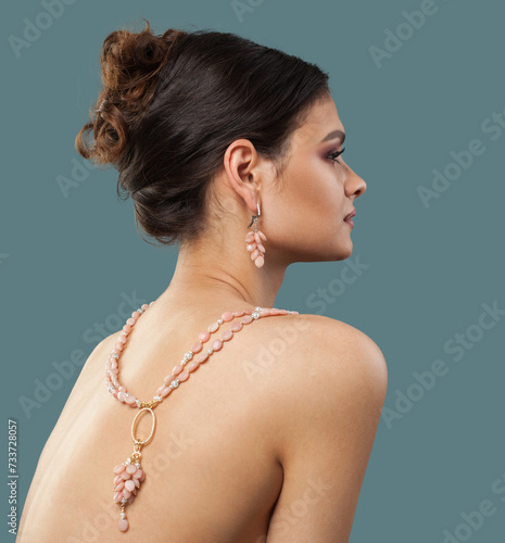 Lovely jewelry model. Woman back with bijou sautoir rope necklace close up photo