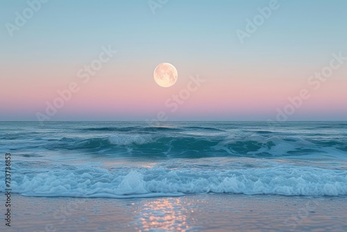 Full moon over blue sea water in pastel sky