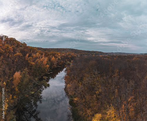 Aerial autumn river landscape and cloudy sky. Wild autumnal riverside nature in Ukraine